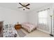 Bedroom featuring tile flooring, neutral walls, and a window for natural light at 10871 Sw 62Nd Avenue Rd, Ocala, FL 34476