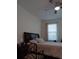 Bedroom with a queen bed and ceiling fan at 10871 Sw 62Nd Avenue Rd, Ocala, FL 34476