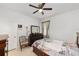 Bright bedroom featuring a ceiling fan, tiled floor, and neutral wall paint at 10871 Sw 62Nd Avenue Rd, Ocala, FL 34476