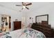 Bright bedroom featuring tiled floor, ceiling fan, and view into en suite bathroom at 10871 Sw 62Nd Avenue Rd, Ocala, FL 34476