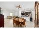 Open dining room with a dining set adjacent to the kitchen and living area at 10871 Sw 62Nd Avenue Rd, Ocala, FL 34476