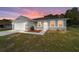Beautiful single-story home with a well-maintained lawn and inviting front entrance at sunset at 10871 Sw 62Nd Avenue Rd, Ocala, FL 34476