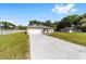 Attractive single-story home with a long driveway, a two-car garage, and a well-kept lawn at 10871 Sw 62Nd Avenue Rd, Ocala, FL 34476