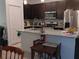 Modern kitchen with dark cabinets, granite countertops, and stainless steel appliances at 10871 Sw 62Nd Avenue Rd, Ocala, FL 34476