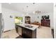 Open kitchen and dining area with island sink and stainless steel appliances at 10871 Sw 62Nd Avenue Rd, Ocala, FL 34476