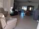 Spacious living room with tile floors and adjacent dining area at 10871 Sw 62Nd Avenue Rd, Ocala, FL 34476