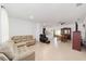 Spacious living room featuring neutral tile flooring and a cozy tan sofa at 10871 Sw 62Nd Avenue Rd, Ocala, FL 34476