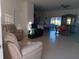 Spacious living room with tile floors and adjacent dining area at 10871 Sw 62Nd Avenue Rd, Ocala, FL 34476