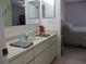 Bathroom with vanity, sink, and view of bedroom at 11752 Sw 139Th St, Dunnellon, FL 34432