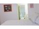 Bedroom with king-size bed and view of en-suite bathroom at 11752 Sw 139Th St, Dunnellon, FL 34432