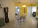 Dining area with table and four chairs, adjacent to kitchen and living room at 11752 Sw 139Th St, Dunnellon, FL 34432