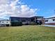 Single story home with covered patio and landscaped lawn at 1628 Bay Meadows Ln, The Villages, FL 32159