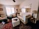 Cozy living room with light beige couch and patterned rug at 1628 Bay Meadows Ln, The Villages, FL 32159