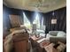 Sunroom filled with moving boxes and comfy chair at 1628 Bay Meadows Ln, The Villages, FL 32159
