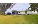 Home's backyard with grassy lawn and trees at 17096 Se 96Th Chapelwood Cir, The Villages, FL 32162