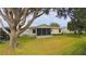 Lovely backyard with ample green space and a screened-in lanai at 17096 Se 96Th Chapelwood Cir, The Villages, FL 32162