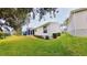 Green backyard featuring well-maintained lawn and lush landscaping around the house at 17096 Se 96Th Chapelwood Cir, The Villages, FL 32162