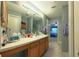 Bathroom features a large vanity and shower, with a view into the bedroom at 17096 Se 96Th Chapelwood Cir, The Villages, FL 32162