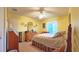 Comfortable bedroom with ceiling fan, large window, and decorative dresser at 17096 Se 96Th Chapelwood Cir, The Villages, FL 32162