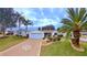 Single-story home with attached garage, landscaped yard, and palm trees at 17096 Se 96Th Chapelwood Cir, The Villages, FL 32162