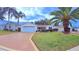 Front view of a single-story house with a garage and well-maintained landscaping at 17096 Se 96Th Chapelwood Cir, The Villages, FL 32162