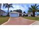 Single-story house with a two-car garage and nicely landscaped front yard at 17096 Se 96Th Chapelwood Cir, The Villages, FL 32162