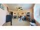 Peach colored Living Room with light and fan at 17096 Se 96Th Chapelwood Cir, The Villages, FL 32162