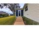 Exterior of a screened-in lanai with an entrance door and steps at 17096 Se 96Th Chapelwood Cir, The Villages, FL 32162