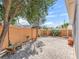 Landscaped backyard featuring a brick patio, mature trees, and privacy fence at 17163 Se 76Th Boxbury Ct, The Villages, FL 32162