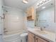 Bathroom with a shower-tub, toilet, sink with cabinet, and neutral wall paint at 17163 Se 76Th Boxbury Ct, The Villages, FL 32162