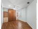 Bedroom with hardwood floors, built-in shelves, a Murphy bed, and a window with blinds at 17163 Se 76Th Boxbury Ct, The Villages, FL 32162