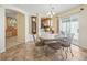 Cozy dining area with a chandelier and access to the kitchen area with tile flooring at 17163 Se 76Th Boxbury Ct, The Villages, FL 32162