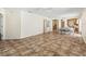 Open-concept dining room with tan tile flooring, a dining table, a ceiling fan, and access to the kitchen at 17163 Se 76Th Boxbury Ct, The Villages, FL 32162