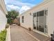 Exterior view of home with sliding glass doors and walkway at 17163 Se 76Th Boxbury Ct, The Villages, FL 32162