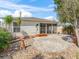 Home's backyard featuring a screened-in porch and stone patio at 17163 Se 76Th Boxbury Ct, The Villages, FL 32162