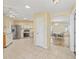 Open kitchen with stainless steel appliances and tile flooring, connected to dining area at 17163 Se 76Th Boxbury Ct, The Villages, FL 32162