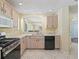 Bright kitchen features stainless steel appliances, ample cabinet space, and tile flooring at 17163 Se 76Th Boxbury Ct, The Villages, FL 32162