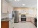 Bright kitchen features stainless steel appliances, ample cabinet space, and tile flooring at 17163 Se 76Th Boxbury Ct, The Villages, FL 32162