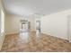 Spacious living room with tile flooring, ceiling fan and natural light from a large glass door at 17163 Se 76Th Boxbury Ct, The Villages, FL 32162