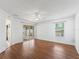 Living room with hardwood floors, a ceiling fan, a sliding glass door, and a window at 17163 Se 76Th Boxbury Ct, The Villages, FL 32162