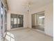 Enclosed sunroom featuring sliding glass doors, a ceiling fan, and neutral flooring at 17163 Se 76Th Boxbury Ct, The Villages, FL 32162
