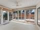 Bright sunroom with ceiling fan and multiple sliding doors to the outdoor patio at 17163 Se 76Th Boxbury Ct, The Villages, FL 32162