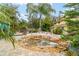 Landscaped backyard with a pond and tropical plants at 19785 Se 156Th St, Umatilla, FL 32784