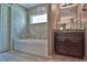Bathroom with dark wood vanity, granite countertop, and large tiled shower at 20 Fisher Trail Pass, Ocklawaha, FL 32179