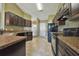 Modern kitchen with dark wood cabinets and granite countertops at 20 Fisher Trail Pass, Ocala, FL 34472