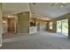 Spacious living room featuring neutral wall tones, carpeting, and an open floor plan at 20 Fisher Trail Pass, Ocklawaha, FL 32179