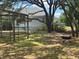 Serene backyard featuring mature trees, offering a peaceful outdoor retreat at 22777 Sw Surf Blvd, Dunnellon, FL 34431