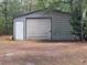 Large metal barn with a roll-up door for storing equipment and tools at 22777 Sw Surf Blvd, Dunnellon, FL 34431