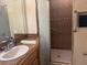 Bathroom vanity with marble counter and a door that leads to the shower at 22777 Sw Surf Blvd, Dunnellon, FL 34431