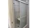 Bright bathroom featuring a shower with glass sliding doors and a convenient seat at 22777 Sw Surf Blvd, Dunnellon, FL 34431